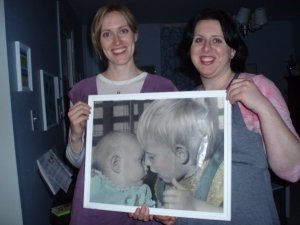 My sister and I in 2009 holding a picture of us